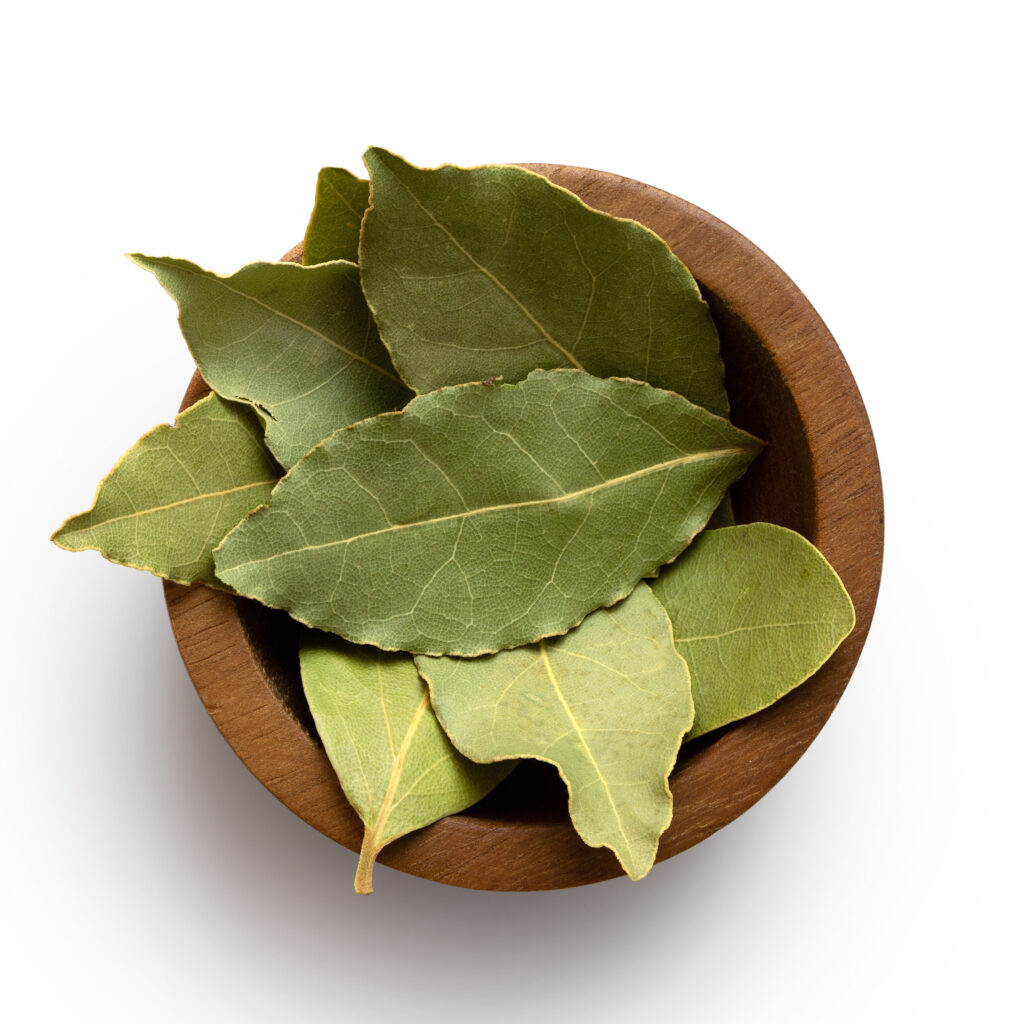 wooden bowl full of dried bay leaves